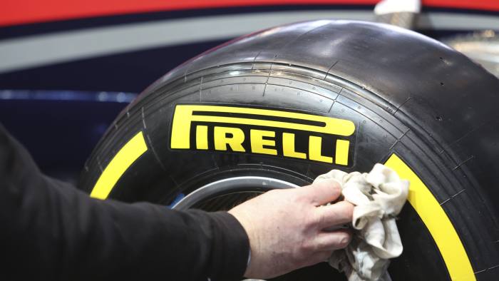 hand with napkin cleaning pirelli tyre
